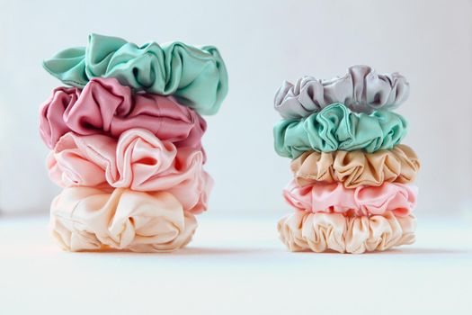 Lot of Colorful silk Scrunchies isolated on white. Luxury Hairdressing tools and accessories. Hair Scrunchies, Elastic HairBands, Bobble Sports Scrunchie Hairband
