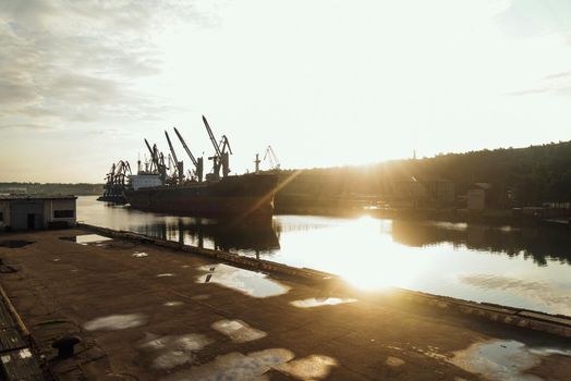 Seaport cargo ship in harbor, image with sunlight effect