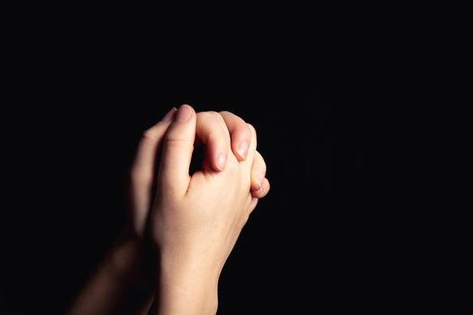 Praying hands with faith in religion and belief in God on blessing background. Power of hope or love and devotion in the dark with copy space , space for text