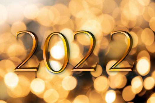 The year 2022 written on wooden cubes in gold luxury letters with shiny bokeh background, New Year celebration concept glitter beauty