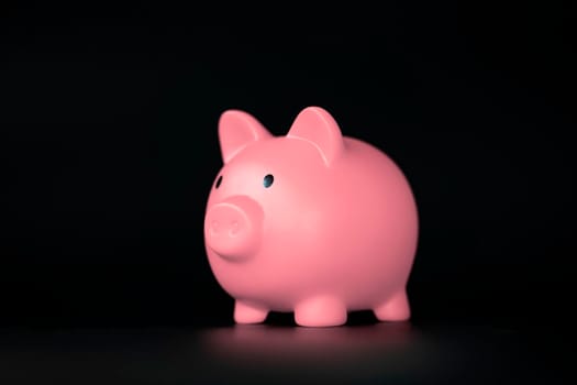 Pink Piggy bank horizontal on black background with copy space, business,savings and financial concept shadows