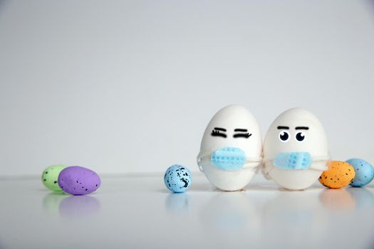 Easter eggs with Corona virus COVID19 protection concepts. DIY Do It Yourself easter eggs wearing mask for Easter holidays decoration on white background Selective focus with copy space. COVID-19 protection coronavirus
