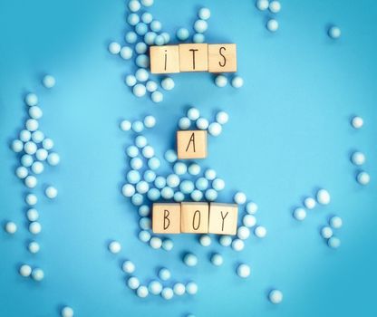 Its a Boy text written with wooden cubes with pastel blue background, Baby Shower or Nursery background Baby announcement. Flat lay,text space. top view copy space, modern concept