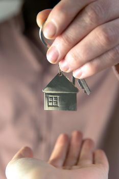 Estate agent giving house keys to client for new home, contract real estate for mortgage approved, focus on keys, business, financial, Estate concept close to