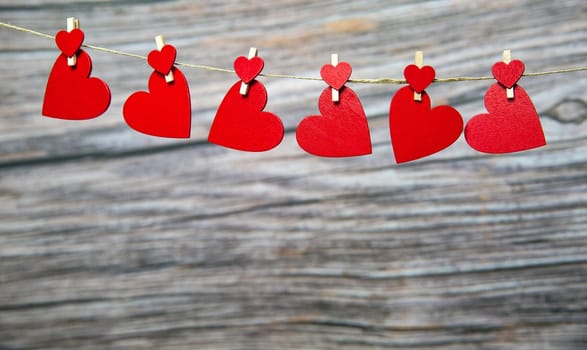 Love concept, red hanging hearts on wooden background for Valentines Day, Mothers Day, Womans day,romantic design copy space space for text