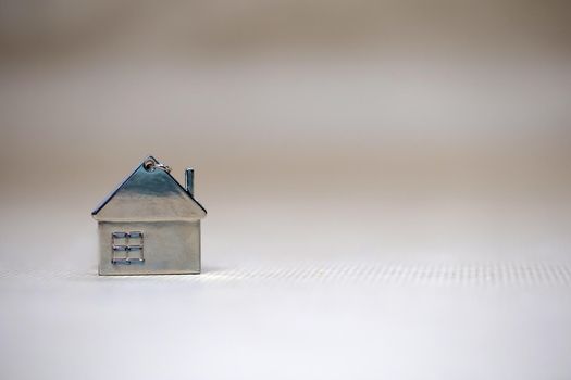 Little miniature house on blurred background, New home, Real Estate, Mortgage loan,architectural concept with Copy space space fot text