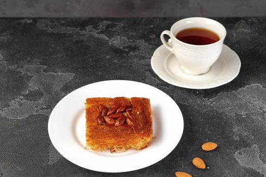 Turkish dessert baklava with nuts on black background, close up