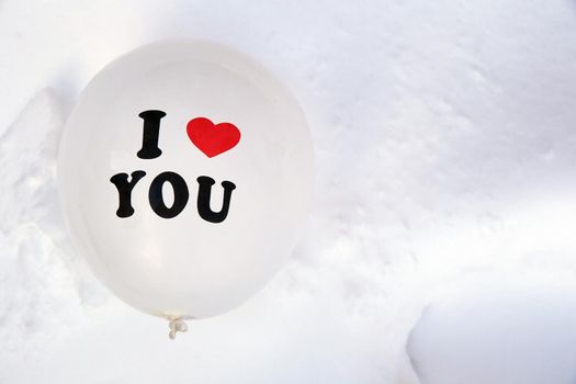 White Valentines Day balloon with the text I love you in fresh white snow background, Copy space, Love,winter,Valentine concept space for text