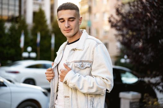 Portrait of handsome young casual man walking on the city street