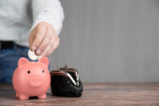 Piggy bank saving currency, person putting coin in for saving money, business, financial, savings and tax concept with copy space space for text