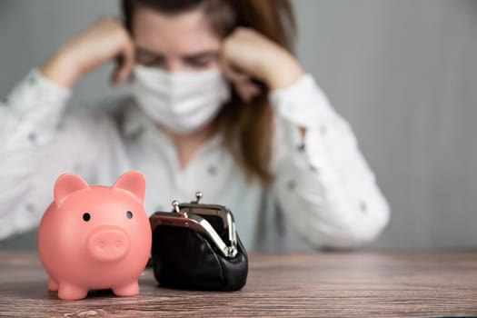 Young Female business woman with pink piggy bank for savings and wearing safety mask for Covid-19, depressed,financial,business,lockdown concept background debts