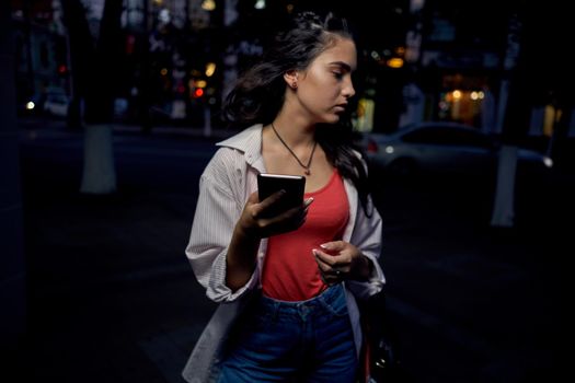 woman with phone in her hands outdoors walk lifestyle summer. High quality photo