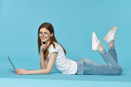 woman with laptop learning internet online education blue background. High quality photo