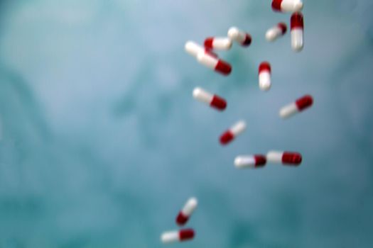 Falling medicine pills defocused blurred background, capsules for Health, Vitamin,drugs concept, copy space modern design space for text
