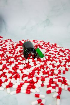 Bottle with red and white capsule on white background, Vitamin,drugs or pharmaceutical medication background, Health, medical and business concept copy space