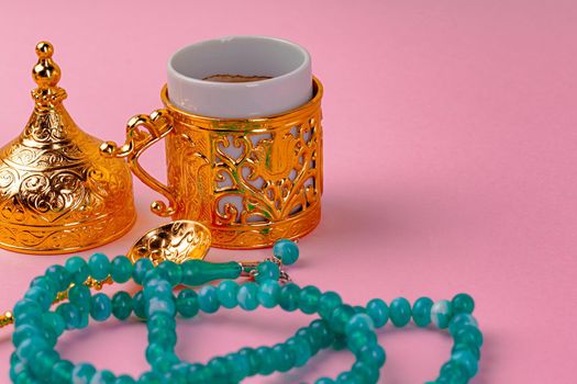 Cup of coffee and turkish dessert baklava on pink background