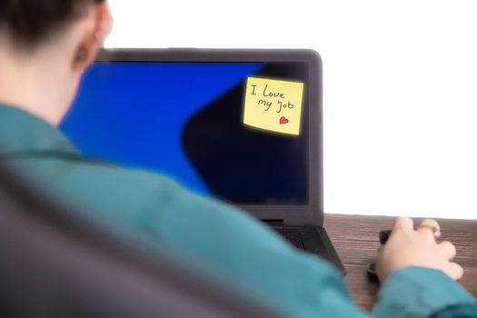 Business woman sitting in her home office with laptop and sticky note with the text I Love my job, business,work, passion,ambition,motivation concept copy space modern background