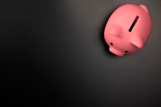 Pink Piggy Bank on a Black background top view with copy space.Savings,Financial and business concept space for text