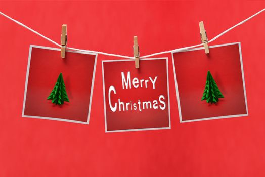 Christmas cards on a clothespins on a red background