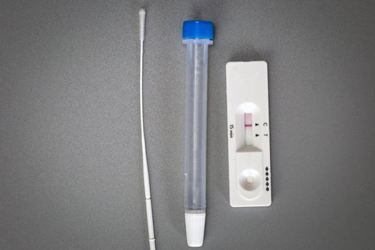 Rapid self test Covid-19 with nose swab, home test kit for coronavirus top view on gray background with copy space space for text negative result