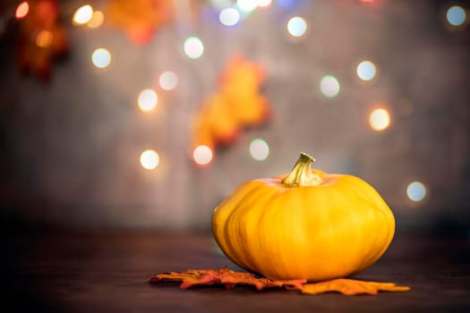 pumpkin on autumn leaves. bokeh background with copy space, colorful design background Halloween and Fall, space for text