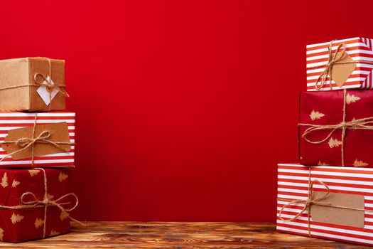 Wrapped christmas gift boxes against red background front view