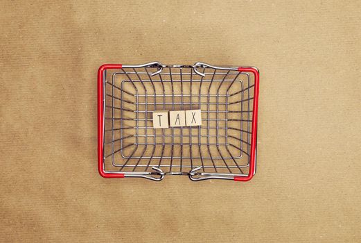 Personal tax income concept, cube wooden block with word TAX with envelope with dollars, business and financial concept copy space top view craft paper