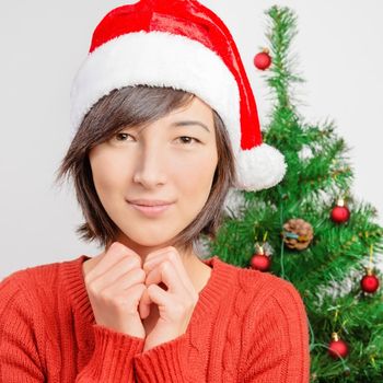 Attractive young woman in santa hat is smiling