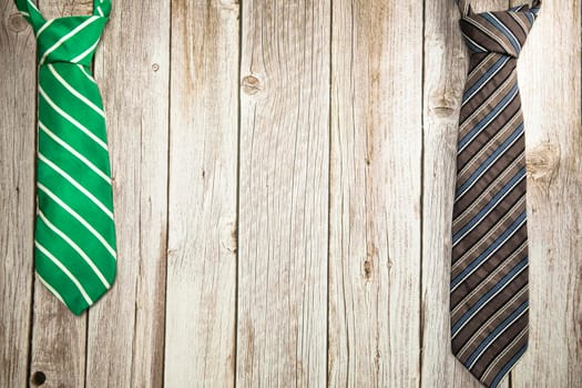 Colorful green and brown necktie on wooden background texture, National men's Day, Father Day design with copy space Space for text