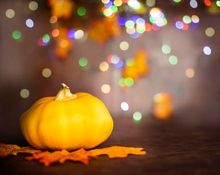 pumpkin on autumn leaves. bokeh background with copy space, colorful design background Halloween and Fall, space for text