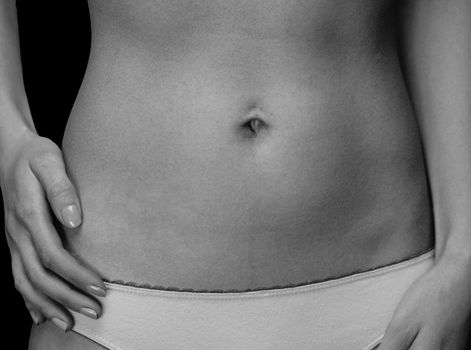 Close-up image of female belly, monochrome image