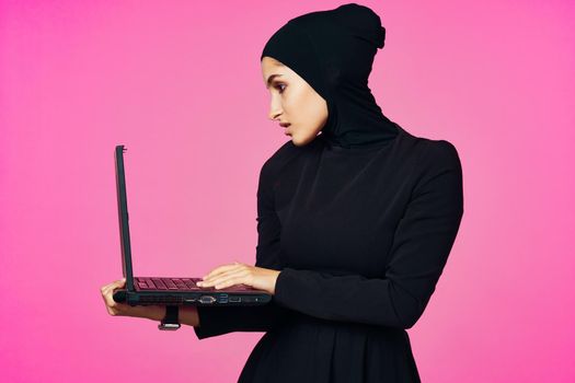 cheerful muslim woman with laptop education student internet technology. High quality photo