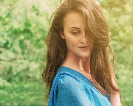 Beautiful brunette young woman with long hair in summer outdoor
