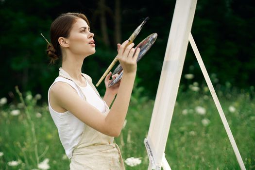 woman outdoors paint a picture landscape hobby creative. High quality photo