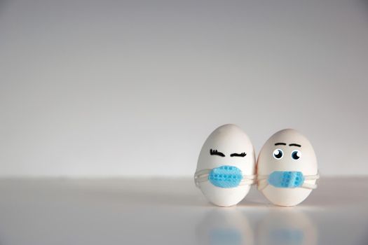Easter eggs with Corona virus COVID19 protection concepts. DIY Do It Yourself easter eggs wearing mask for Easter holidays decoration on white background Selective focus with copy space. COVID-19 protection coronavirus