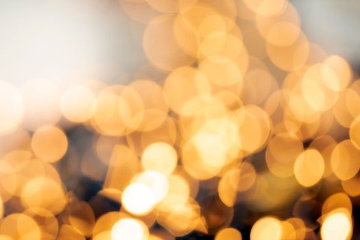 Defocused gold light abstract Christmas or Holiday background texture, sparkling yellow blurred warm tones colorful