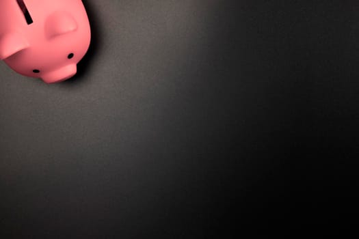 Pink Piggy Bank on a Black background top view with copy space.Savings,Financial and business concept space for text