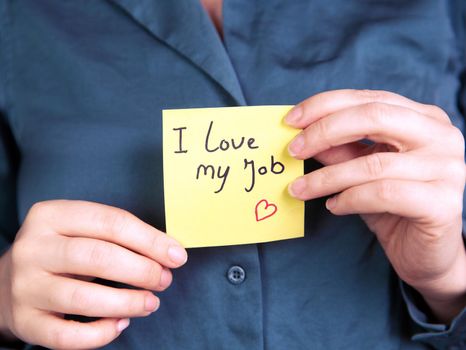 I Love My Job Note in hand, business woman or man with yellow sticky note with positive achievement, business,goals,education,people concept close up