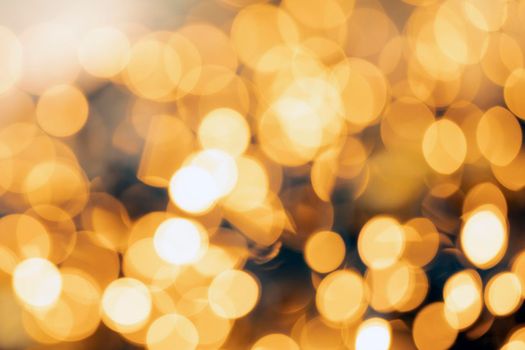 Defocused gold light abstract Christmas or Holiday background texture, sparkling yellow blurred warm tones colorful