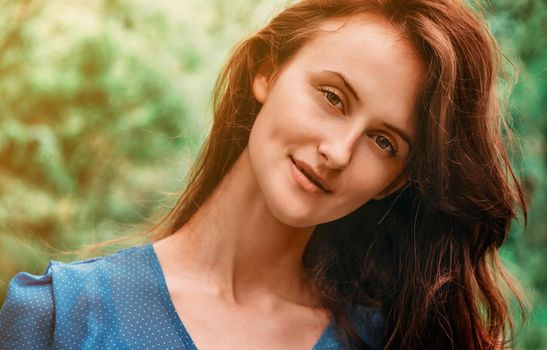 Portrait of attractive brunette young woman with long hair in summer outdoor
