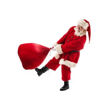 Santa Claus with a big bag on isolated white background. Funny Santa throw large sack of Christmas gifts. Cheerful Santa Claus spin bag with gifts.
