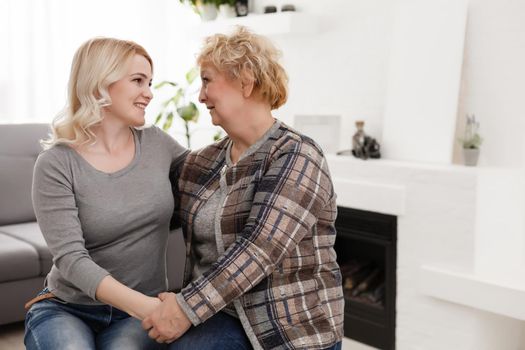 happy senior mother and adult daughter closeup portrait at home