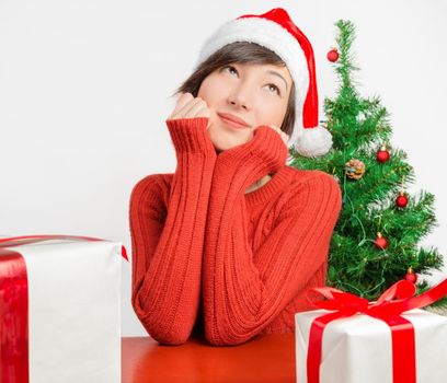 Young happy woman dreams about presents for the new year
