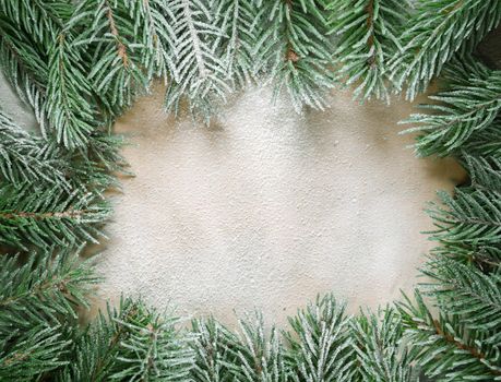The branches of trees covered with snow on the background of old paper, copyspace