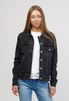 girl in a denim black jacket and blue denim pants on a white background.