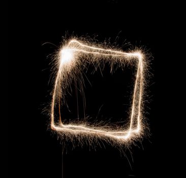 Frame shape made of sparklers on black background