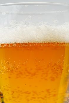 Beer textute can be usedas background. soft focus. Close up of beer with few bubbles and copy space. Fresh golden beer drink in glass.