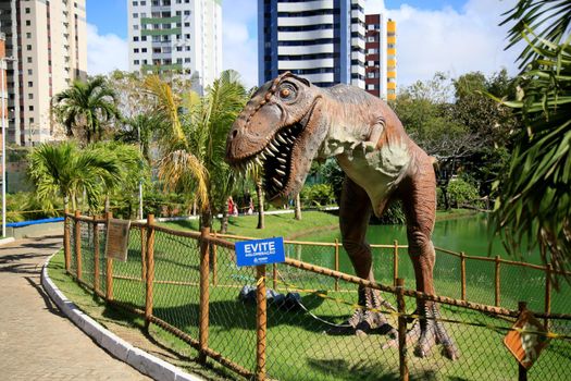 salvador, bahia, brazil - july 20, 2021: T-Rex dinosaur sculpture is seen in the Lagoa dos Dinossauros park in the city of Salvador.