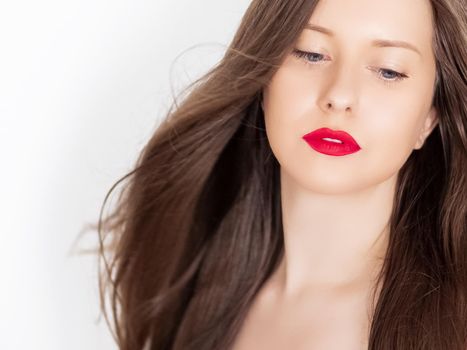 Beautiful woman with healthy gorgeous long hair, natural brunette hairstyle and red lipstick makeup, haircare and beauty ad.