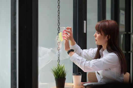 business woman post it notes idea discussing and planning in glass wall, Business financial concept